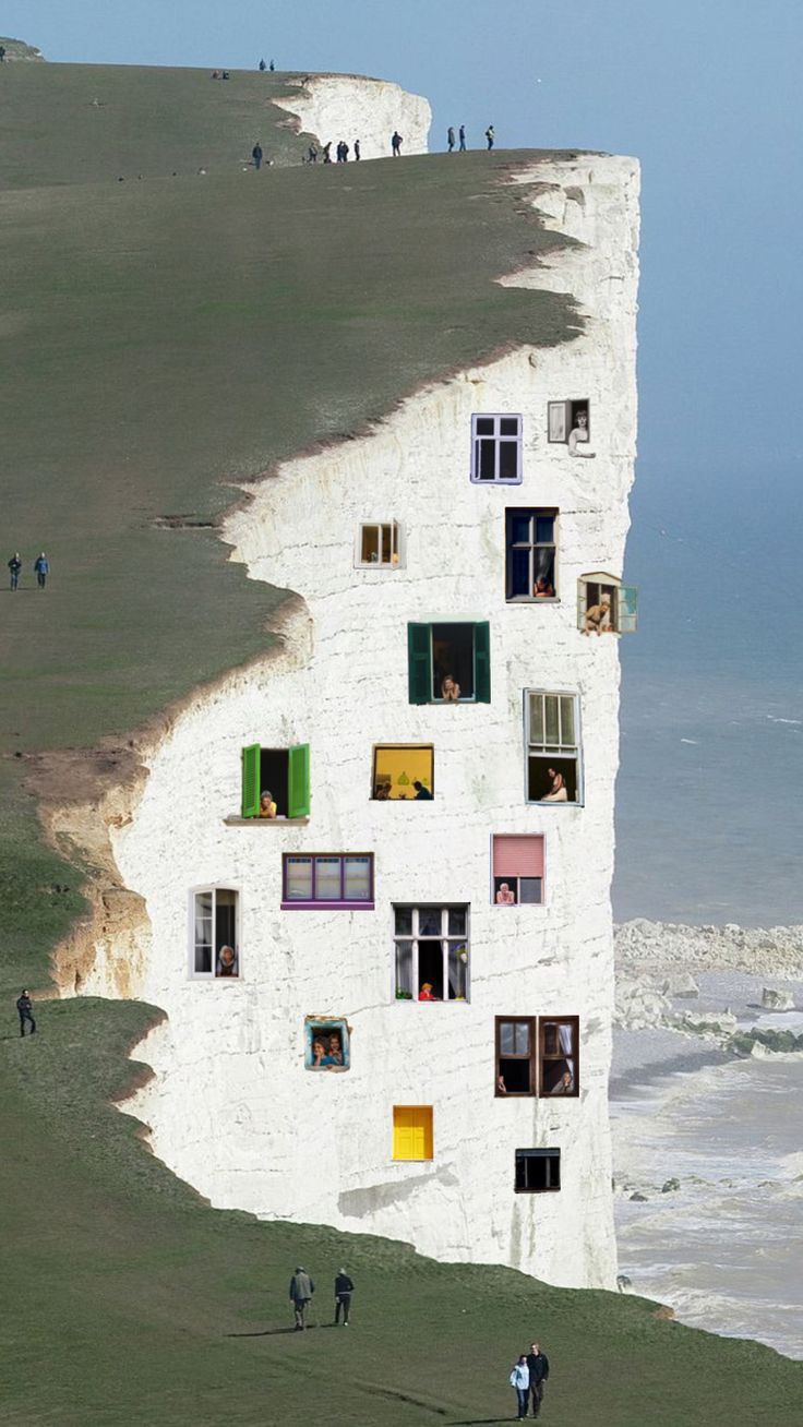 Surreal collage of a chalk cliff face fitted with windows like an apartment building, overlooking the sea